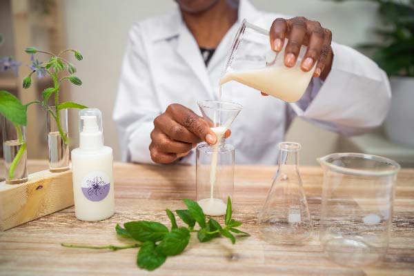 Beauty Cosmetics Emailing Campaign – founder formulating skincare serum in lab with natural ingredients