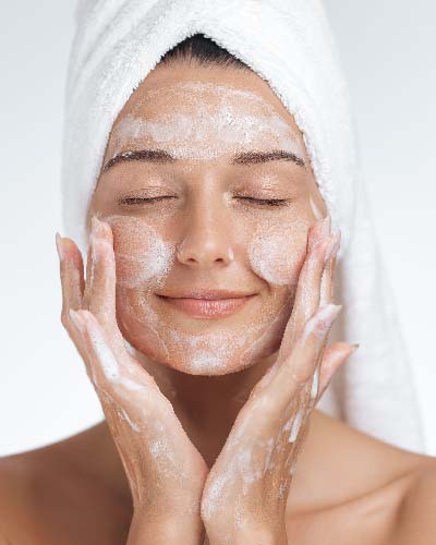 Beauty Cosmetics Product Description woman gently cleansing face with soft facial cleanser